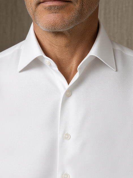 Man in a crisp white poplin shirt with a strong collar under a business suit